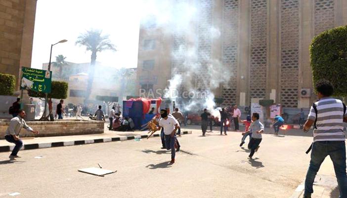 بالصور.. اشتباكات عنيفة بين طلاب “القاهرة” وأفراد “فالكون”